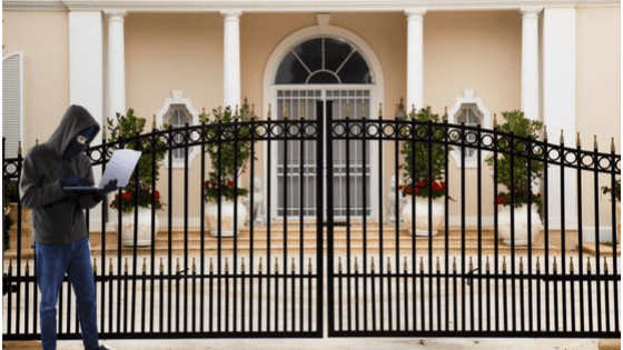Hacker at the front gate of a luxury home
