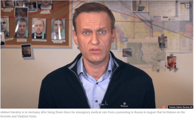 picture of Putin opposition leader Navalny in his office.