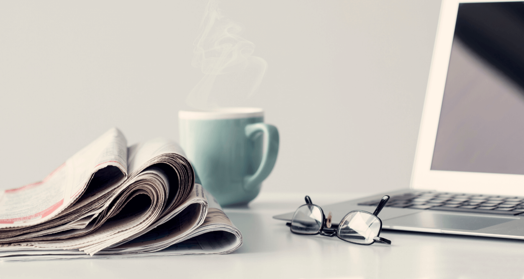 newspapers laptop and coffee green cup-1