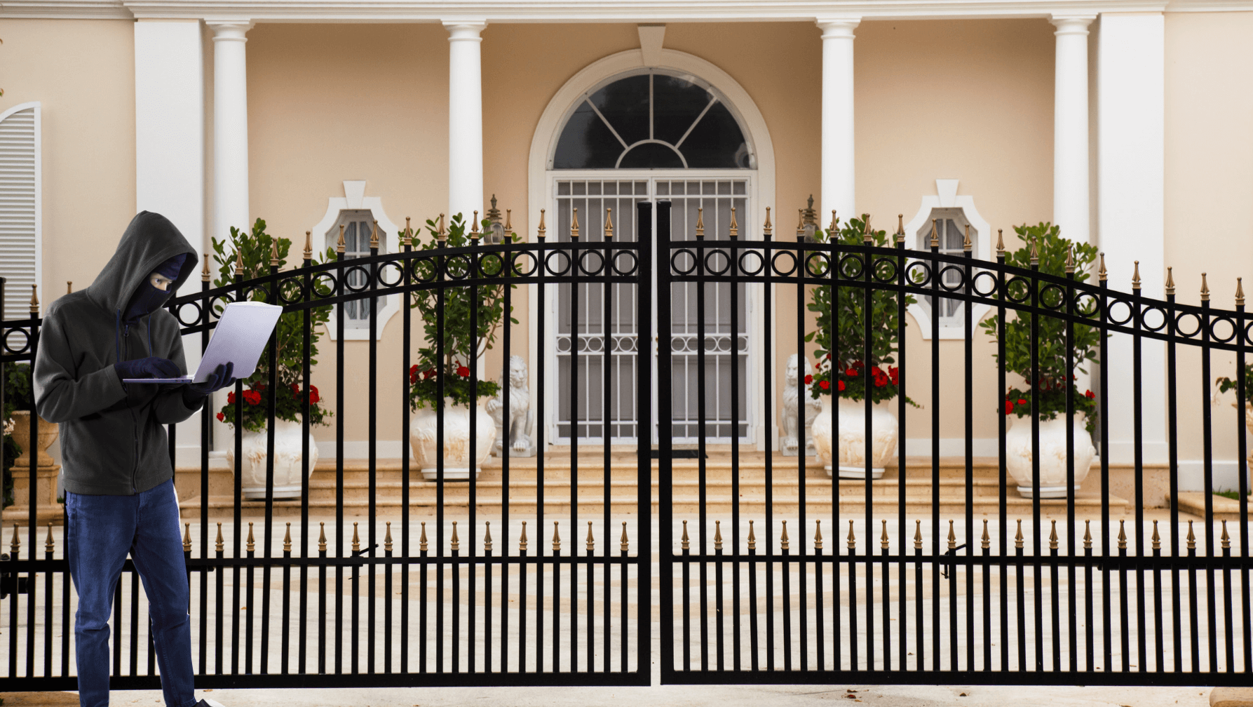 a black wrought iron gate at the entrance to the private home of a VIP and wealthy family
