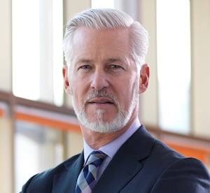 gray haired and bearded man portrait in suit and tie